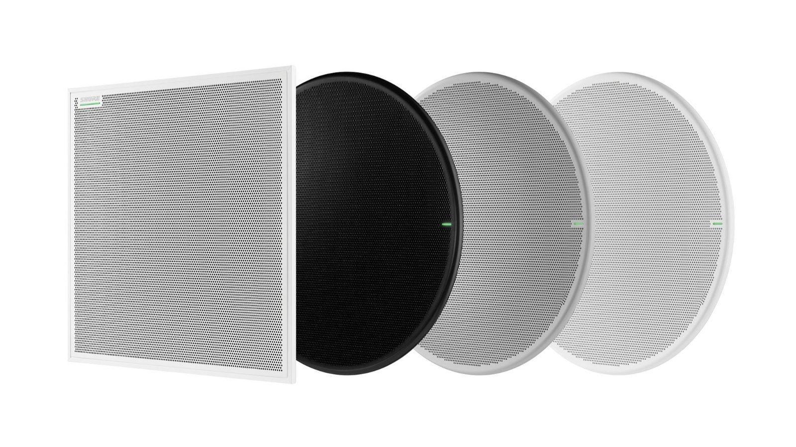 a set of three round speakers with black and white covers